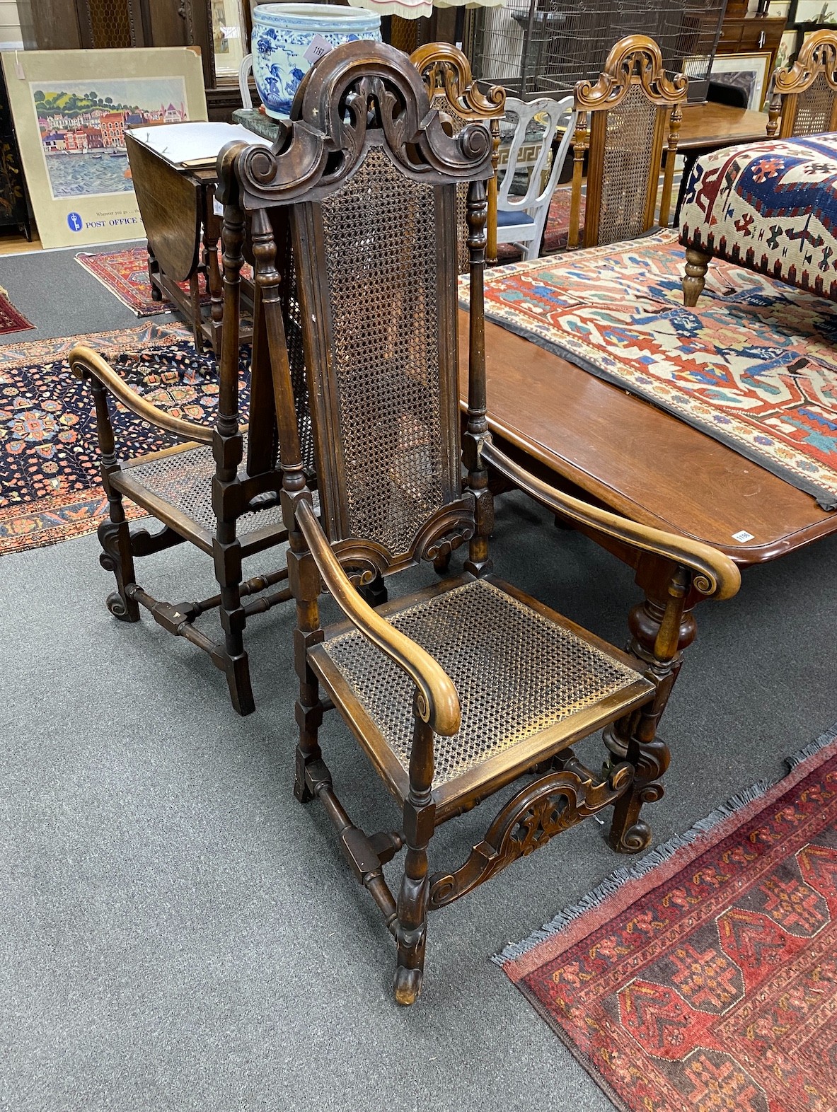 A set of ten early 20th century Jacobean Revival caned beech and walnut high back dining chairs, two with arms, standard chairs have drop in seats, elbows are caned.